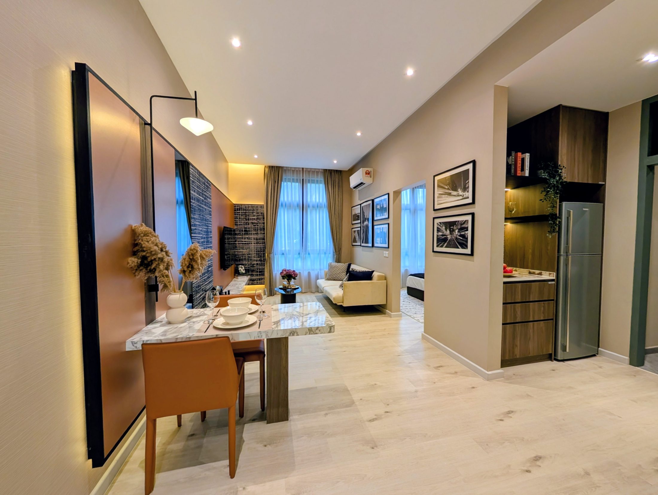 Living and dining space of an i-nova show unit, daylight from a full-height window